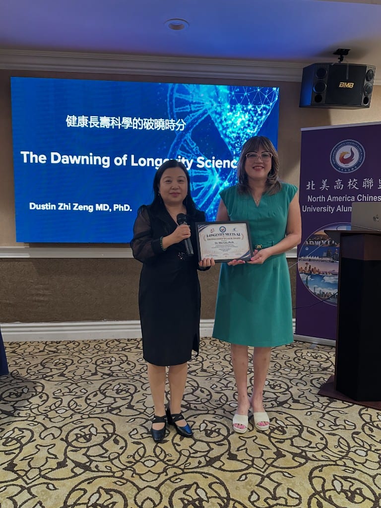 Dr. Min Cole receiving the Longevity Meets AI Distinguished Speaker Award