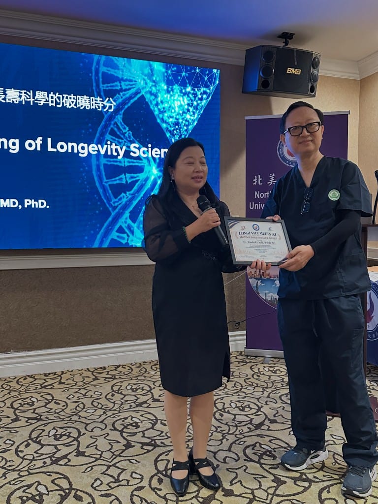 Dr. Dustin Zhi Zeng receiving the Longevity Meets AI Distinguished Speaker Award